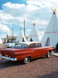 50s Style car parked in front of a Wigwam (teepee) at Wigwam Villages Motel.