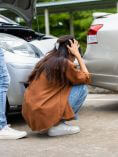 Stressed woman looking at fender bender