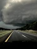 Ominous clouds over road.