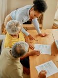 Couple looking at paperwork with a professional looking person.