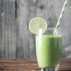 Photo of a cup of lime punch with a lime wedge