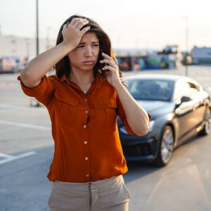 Woman stressed out about her car broken down on the road