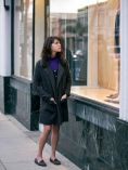 Woman looking sad while window shopping.